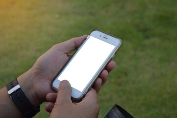 Asian male hand holding a white screen phone on natural background.