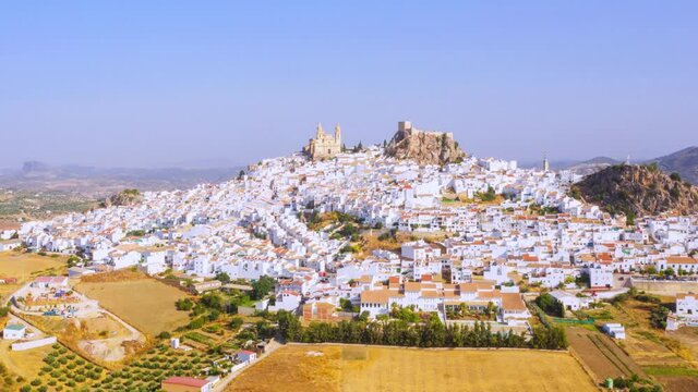 Olvera, Spain. Aerial view of old touristic town Olvera, Spain surrounded by mountains. Dry landscape in hot summer, White houses in Spanish village, time-lapse, panning video