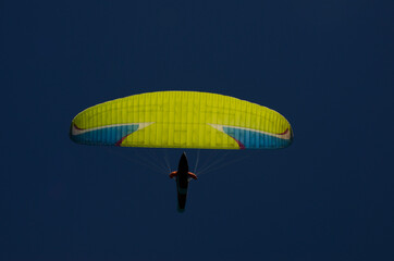 paraglider seen from below with deep blue sky in the background