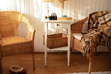 Cozy Skandinavian interior home with wicker rattan armchairs in living room. Rattan chair and...