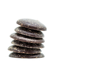 A Studio Photograph of Dark Chocolate Buttons against a White Background