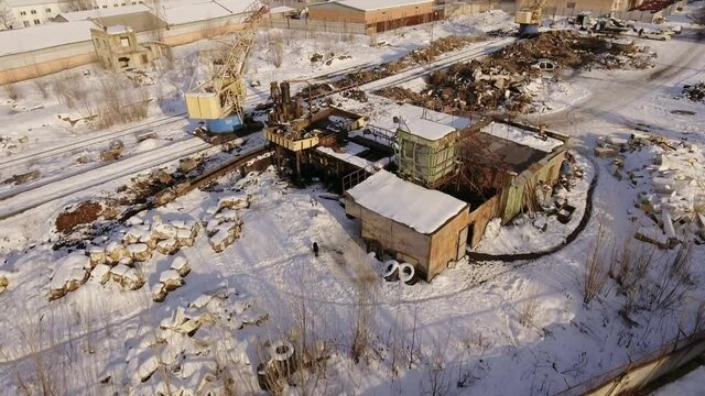 Aerial photography of scrap metal dump, Crane unloads, loads scrap metal in a railway car.