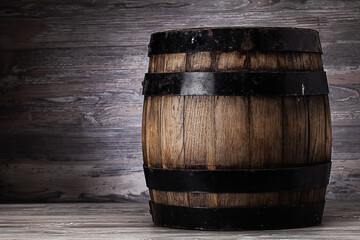 Old wooden barrel standing on table in old cellar