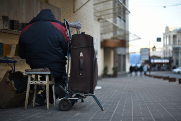 disabled beggar sells books on the street