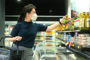 new normal after covid epidemic young smart asian female shopping new lifestyle in supermarket with...