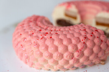 Pink mousse cake in the form of a donut in circles