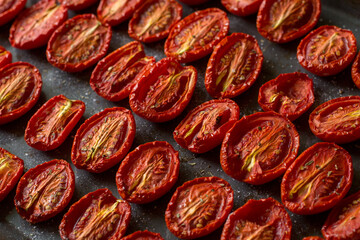 Cooking sun-dried tomatoes in the oven in the kitchen