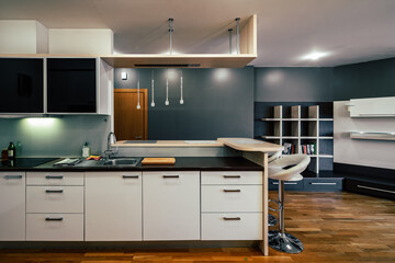 Contemporary interior of kitchen in luxury flat. Modern kitchen set with sink.