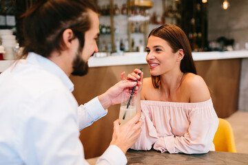 Young happy couple at date in a cafe