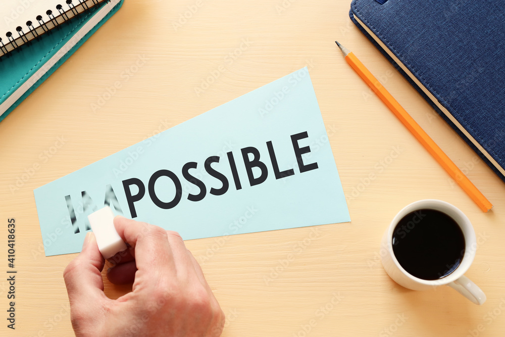 Poster man erasing card with the text impossible, cutting the word im so it written possible. success and c
