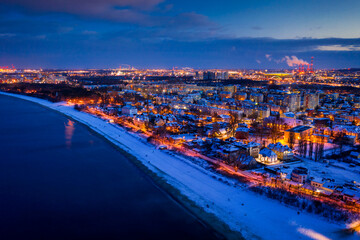 Cityscape of Gdansk Brzezno by the snowy beach at dusk. Poland