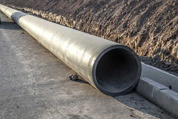 Large diameter plastic pipe at a construction site.