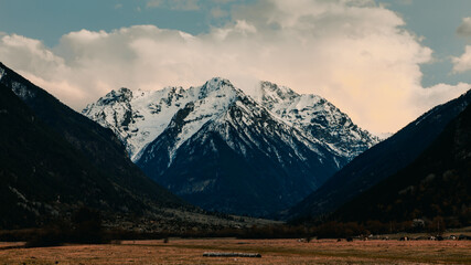 view of the snowy mountain top from the river valley