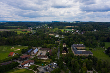 Fototapeta na wymiar Aerial view of the palace in Tambach close to Weitramsdorf in Germany on a sunny day in spring. 
