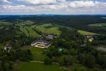 Fototapeta na wymiar Aerial view of the palace in Tambach close to Weitramsdorf in Germany on a sunny day in spring. 
