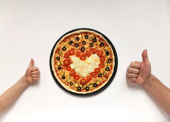 Pizza for Valentine's Day with red heart of cherry tomatoes. February 14 holiday concept and hand thumbs up