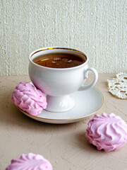 Cranberry marshmallow and a cup of tea on the table. Delicious breakfasts. Sweets.