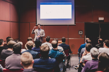 Speaker Giving a Talk at Business Meeting. Audience in the conference hall. Business and Entrepreneurship concept.