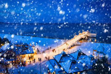 Snowy night at the pier in Brzezno on the beach of Baltic Sea, Gdansk.  Poland.