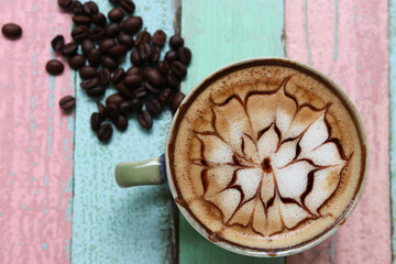 Spider web pattern beautiful design for Latte coffee  foam decorate with beans on retro table