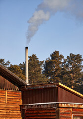smoke coming from the chimney of a village house