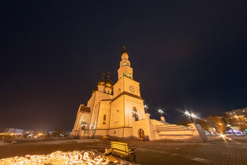 Night photo of an orthodox cathedral. Golden domes in the light of street lamps. Russia. Abakan