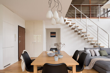 Dining table in interior with stairs