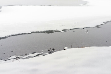 Frozen lake, snowy day in winter cold day.