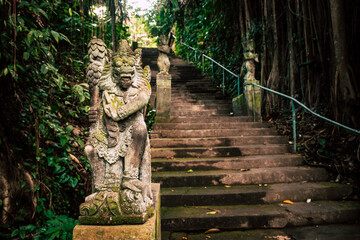 A typical Indonesian sculpture. Statues or hindu god stand in front of a staircase in the center of Ubud, Bali.