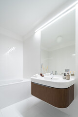Fototapeta na wymiar Mirror wall above modern washbasin