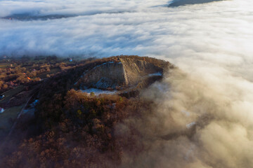 Amazing geological formatoion with fog. Basalt columns hill in upper Balaton region in Hungary. The...