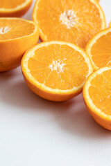 The orange halves are on the table. On a gray and white background.