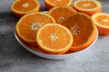 The orange halves are on the table. On a gray and white background.