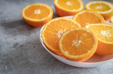 The orange halves are on the table. On a gray and white background.