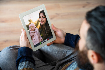 Happy friends in video call on tablet - Mom with little baby girl at the park meet father online with remote smartphone webcam - Brother hangout with sister and granddaughter
