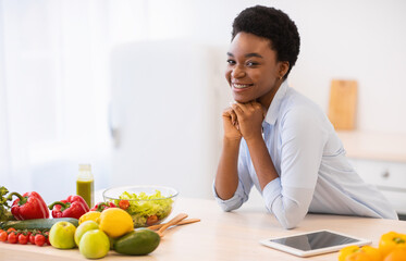 Black Woman Posing In Kitchen Standing Near Table At Home