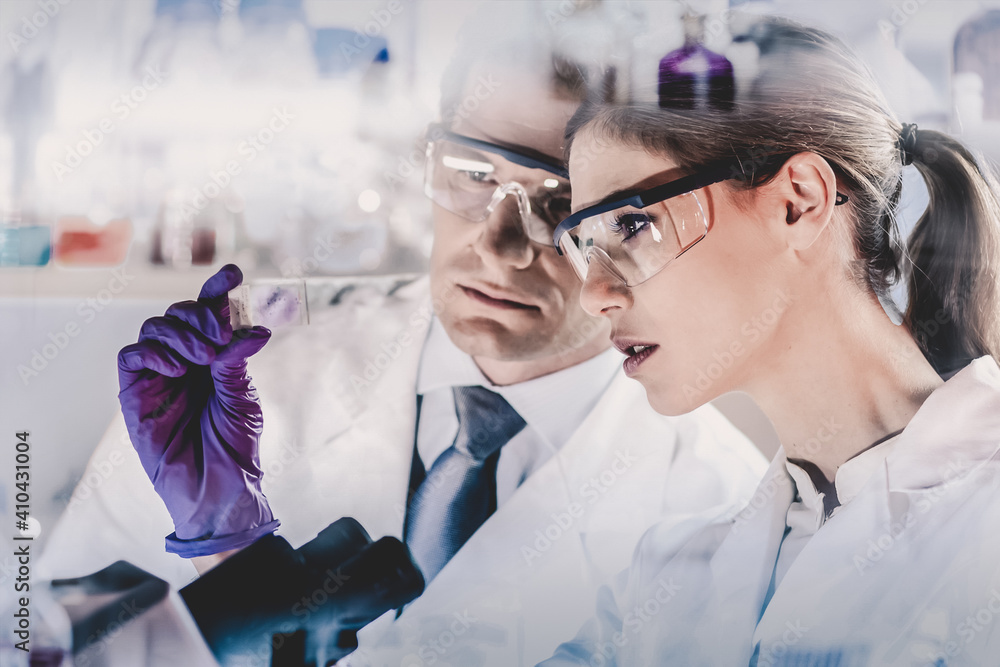 Aufkleber Attractive young scientist and her post doctoral supervisor looking at the microscope slide in the forensic laboratory.