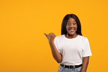 Positive african american woman pointing at empty space