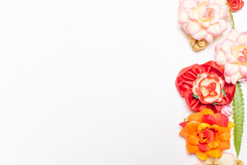 Frame made of rose flowers on white background. Top view with copy space.