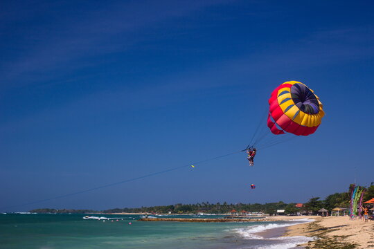 Parachute entertainment on the beach on the island of Bali.