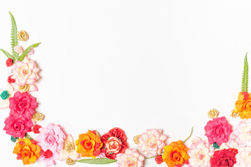 Frame made of rose flowers on white background. Top view with copy space.