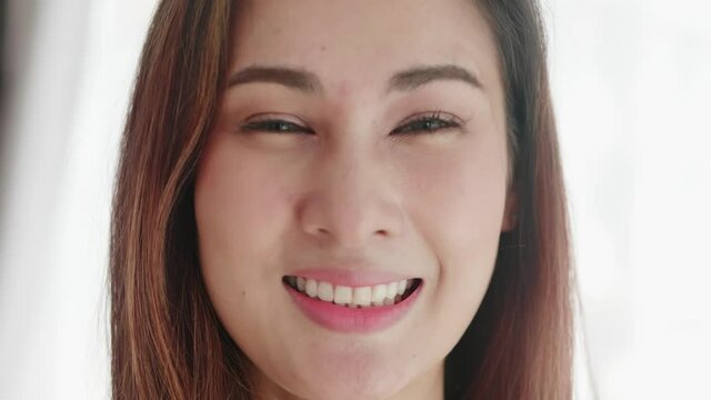 Close up of very beautiful Asian woman smiling in a very cute way and very happy