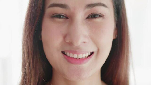 Close up of very beautiful Asian woman smiling in a very cute way and very happy