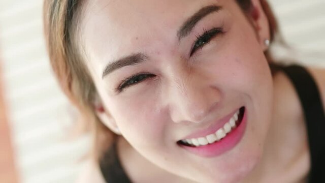 Close up of very beautiful Asian woman smiling in a very cute way and very happy