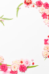 Frame made of rose flowers on white background. Top view with copy space.