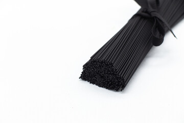 Black pasta on a white background. Black spaghetti