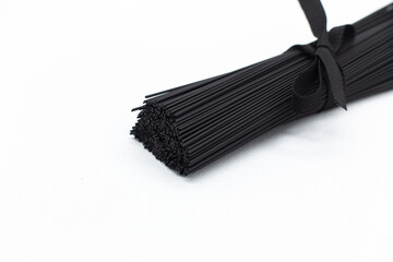 Black pasta on a white background. Black spaghetti