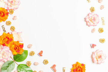 Frame made of rose flowers on white background. Top view with copy space.