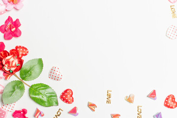 Frame made of rose flowers on white background. Top view with copy space.