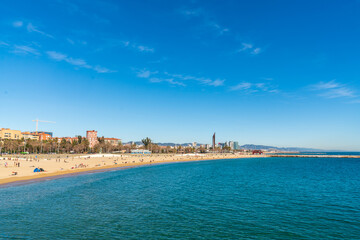 BARCELONA, SPAIN, FEBRUARY 3, 2021: Barcelona beach a sunny winter day. During the covid-19 pandemic. View from inside the water.